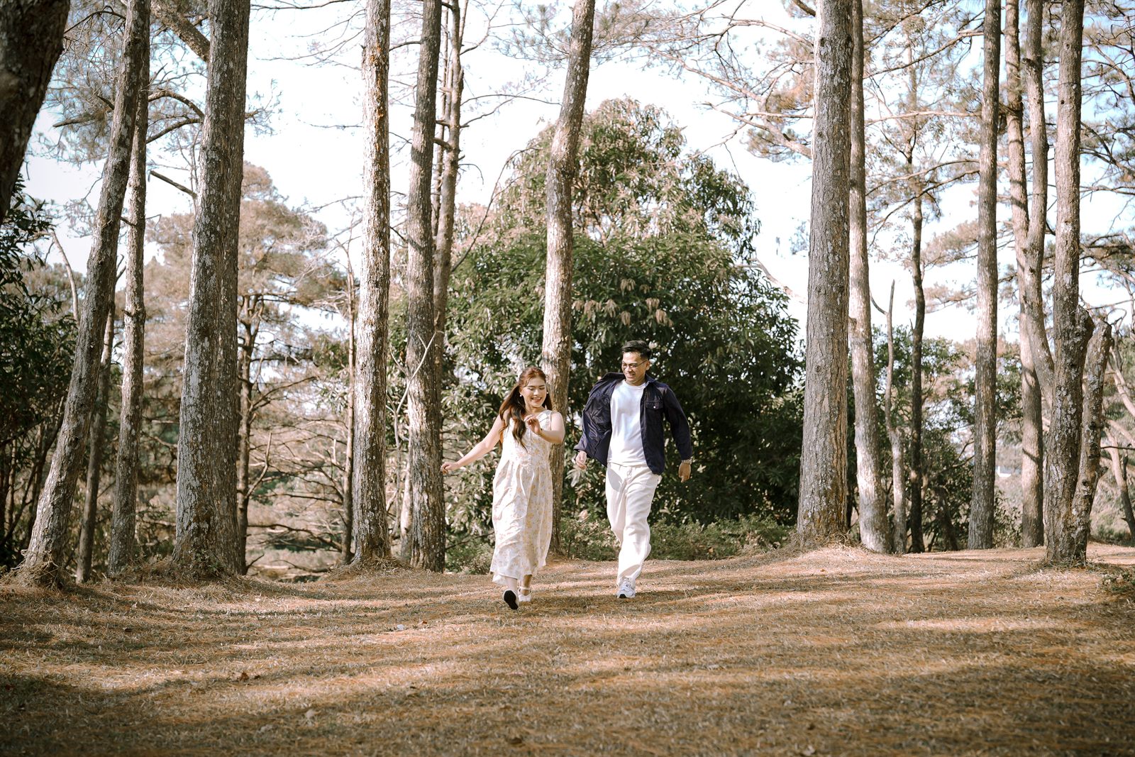 Caren and Zayrol running joyfully through the forest